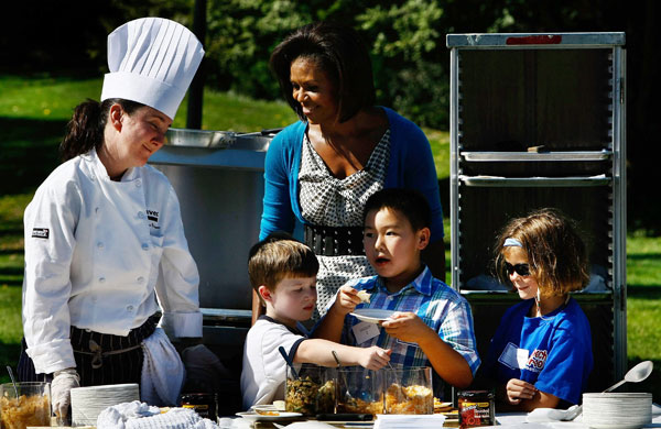 Michelle Obama: Michelle Obama works with students on preparing healthy meals