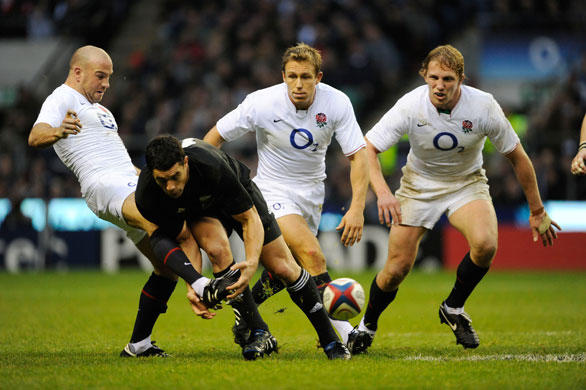 England v All Blacks: Paul Hodgson kicks the ball from the grasp of Dan Carter