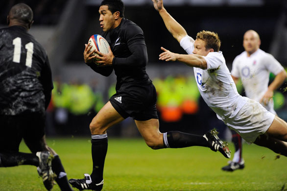 England v All Blacks: Mils Muliaina evades the flying tackle of Jonny Wilkinson