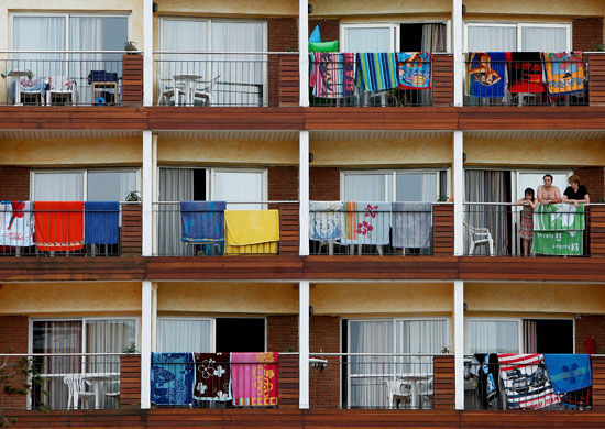 Costa Brava or Bahamas?: Towels outside holiday apartments in Lloret de Mar, Costa Brava, Spain.