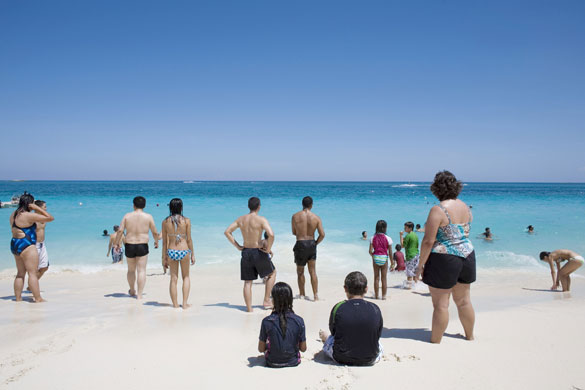 Costa Brava or Bahamas?: Tourists sunbathe along the beach in Nassau, Bahamas.