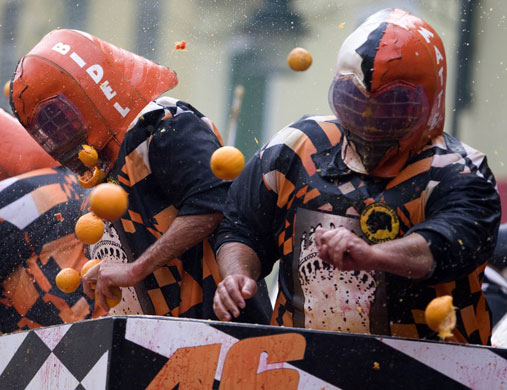 Carnival: Rival teams pelt each other with orangesat carnival in Ivrea Italy