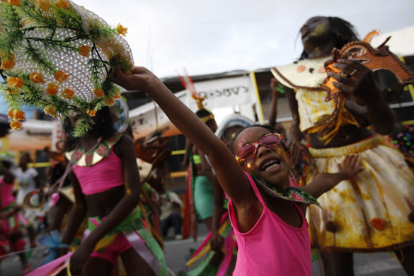 Carnival: Port-of-Spain, Trinidad: Children dance to  soca as they perform carnival 