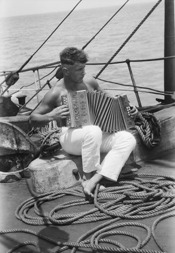 Alan Villiers: A sailor and his accordion onboard the Parma by Alan Villiers