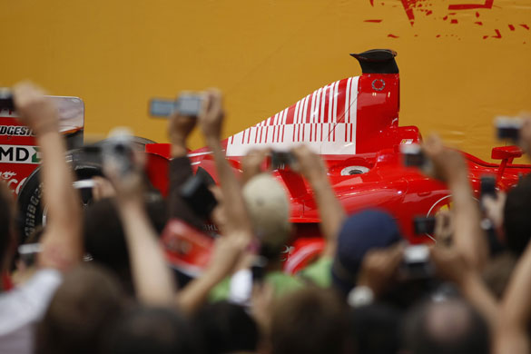 24sport: Members of public take photographs of a Ferrari Formula One car