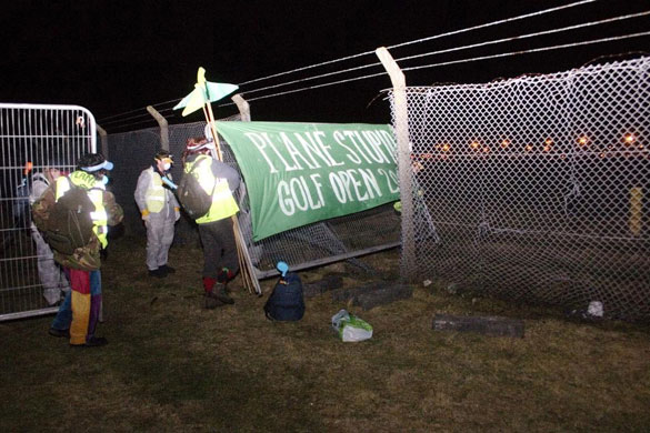 Plane Stupid: A group of climate protesters break through the fence at Aberdeen airport