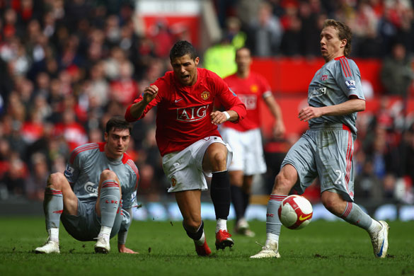 Cristiano Ronaldo: Ronaldo is tackled by Albert Riera of Liverpool