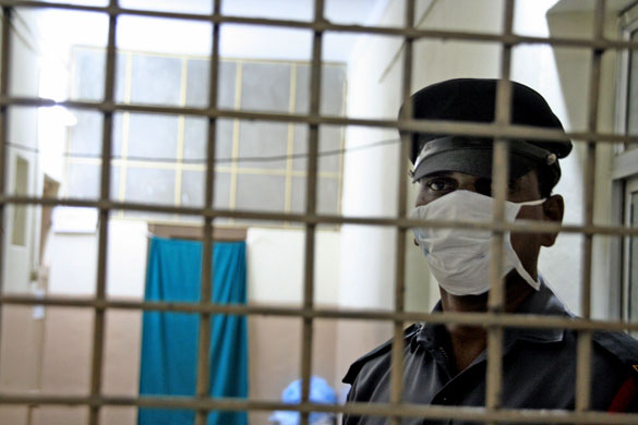 Swine flu pandemic: Hyderabad, India: A security guard patrols at an isolation ward