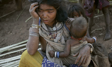 A tribal woman with her child near the mining site of the alumina refinery in Orissa state. Photograph: Parth Sanyal /Reuters