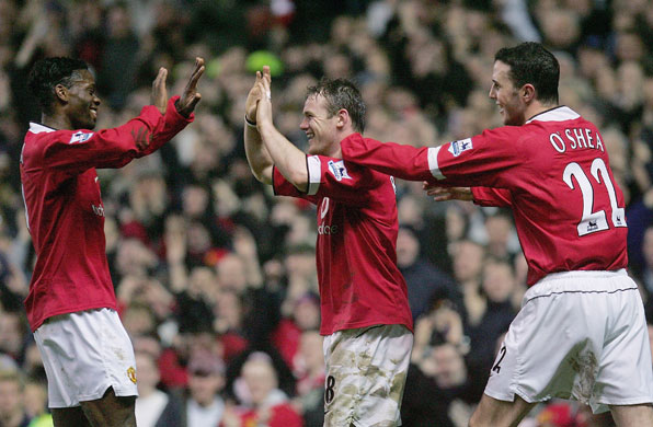 Wayne Rooney Top Ten: Wayne Rooney celebrates with Evra and O'Shea after scoring his first goal