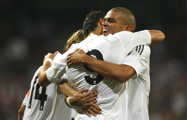 1 champ league draw: Real Madrid's Pepe hugs Cristiano Ronaldo
