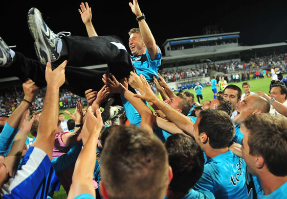 2 champ league: Dan Petrescu, coach of Unirea Urziceni, celebrates with his team 