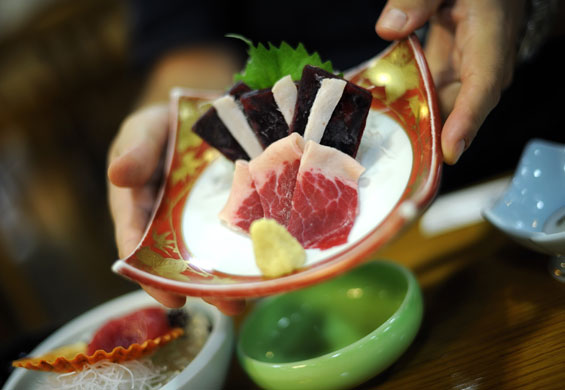 Dolphins in Japan: Whale meat sashimi is served with fresh ginger at a hotel in Taiji