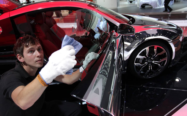 Frankfurt motor show: A worker cleans an R8 sports car from German car manufacturer Audi 
