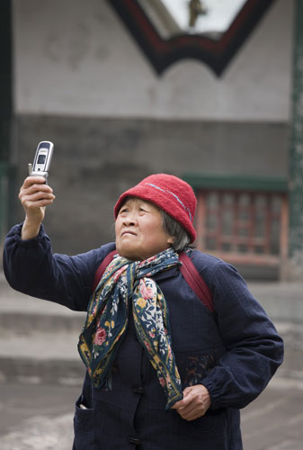 Rise of the camera-phone: A woman captures the Summer Palace in Beijing