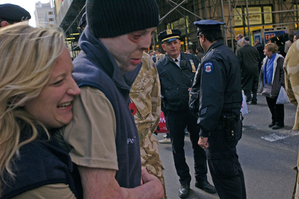 Isolation: A disfigured solider is hugged by his wife on a New York street