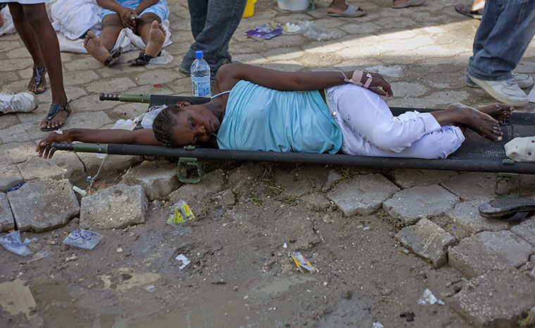 Cholera in Haiti: A woman suffering from cholera symptoms waits for treatment 