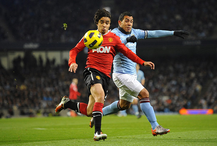 Man City v Man Utd: Rafael da Silva beats Carlos Tevez to the ball