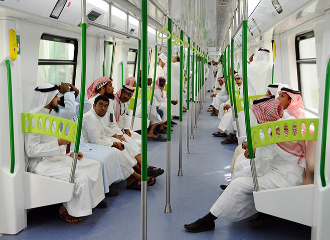 Hajj In Mecca: Saudi Arabian men ride on the newly-opened Holy Sites metro light railway