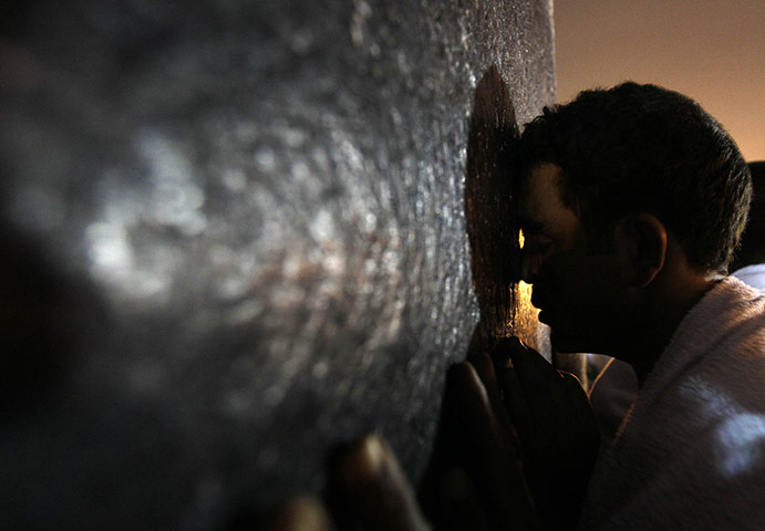 Hajj in Mecca: A Muslim pilgrim prays on a rocky hill called the Mountain of Mercy