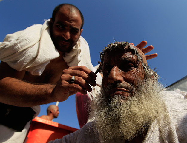 Hajj Pilgimage: A Muslim pilgrim has his head shaved