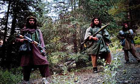 Haqqani Taliban fighters carrying guns in their mountain camp
