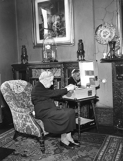 75th Anniversary of RNIB Talking Books: A woman listens to her gramophone in her sitting room