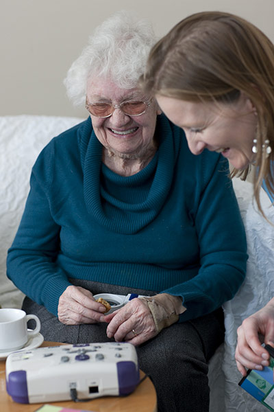 75th Anniversary of RNIB Talking Books: A woman shows another woman how to use a digital Talking book player
