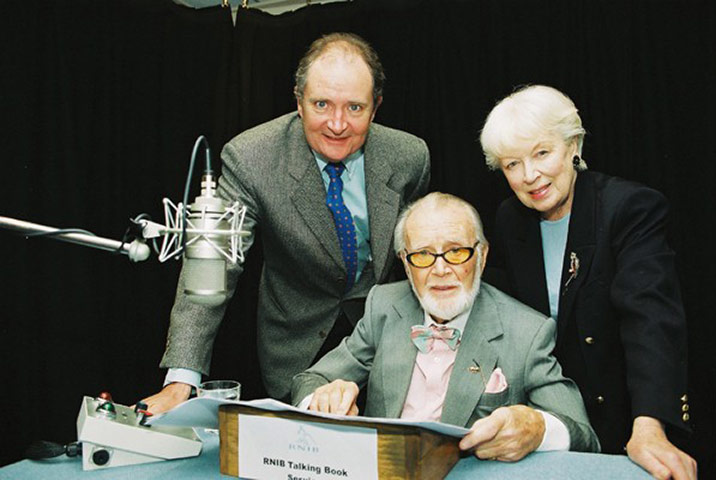 75th Anniversary of RNIB Talking Books: Three celebrities pose by a microphone