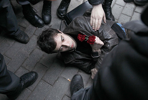 24 hours in pictures: Russian police surround an opposition party supporter