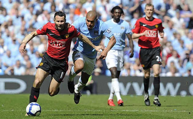 City v United: Ryan Giggs runs away from Nigel De Jong