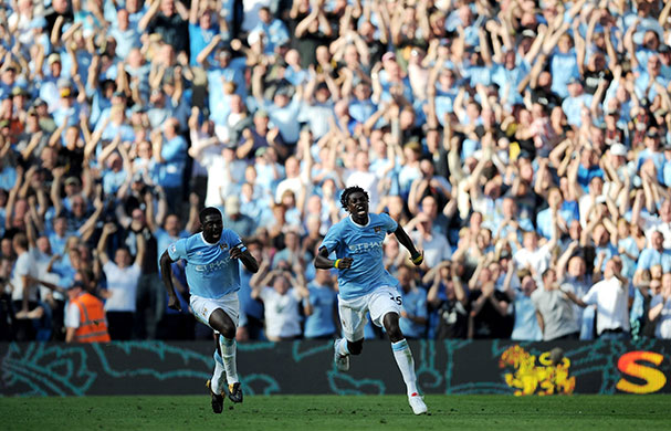 Title race gallery: Adebayor celebrates after scoring for Manchester City against Arsenal