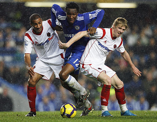 Title race gallery: Chelsea's John Mikel progress is blocked by two Wolves players