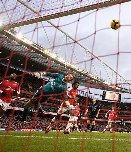 Title race gallery: Manuel Almunia tips a Nani chip into his own net