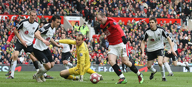 Title race gallery: Man Utd's Wayne Rooney goes around Fulham keeper Mark Schwarzer