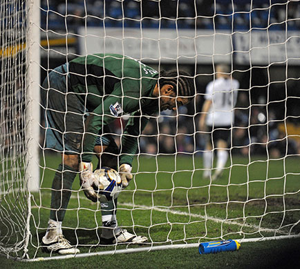 Title race gallery: Pompey keeper David James picks the ball out of the net 