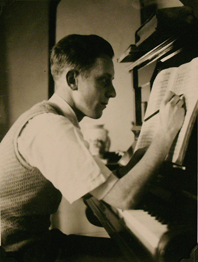 Sir Charles Mackerras: Charles Mackerras writing music at the piano in Pembridge Crescent, 1951