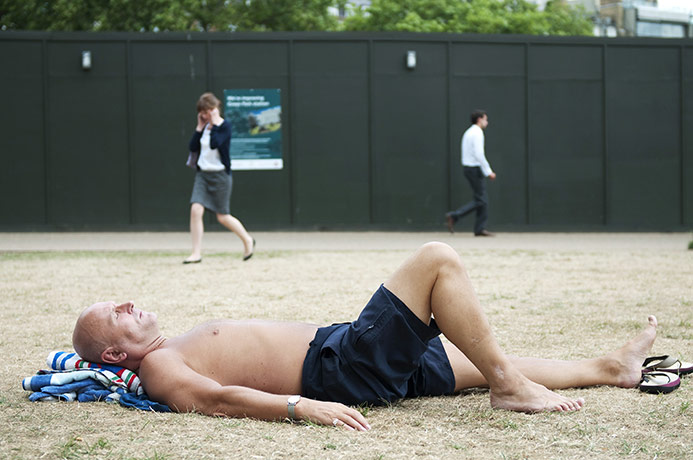 Sunbathers in Green Park, London