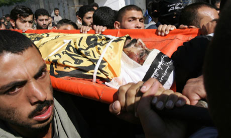 Palestinian mourners carry al-Aqsa Martyrs Brigade commander Hassan al-Madhoun during his funeral