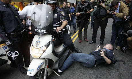 A police officer on a scooter runs over a legal observer at an Occupy Wall Street demonstration