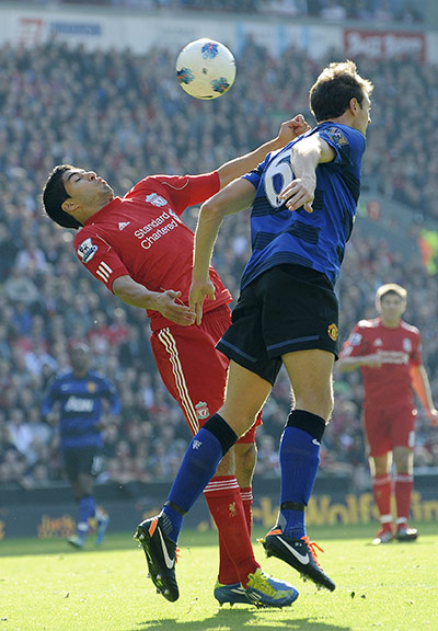 Liverpool v United: Suarez and Evans contest a high ball