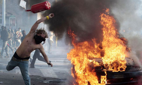 A protestor hurls a canister during clashes in Rome 