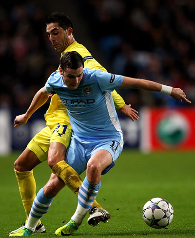 Tuesday Champions League: Adam Johnson of Manchester City tangles with Villarreal's Bruno Soriano