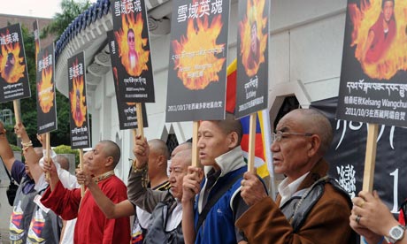 Tibetans display portraits of people who killed themselves in self-immolation