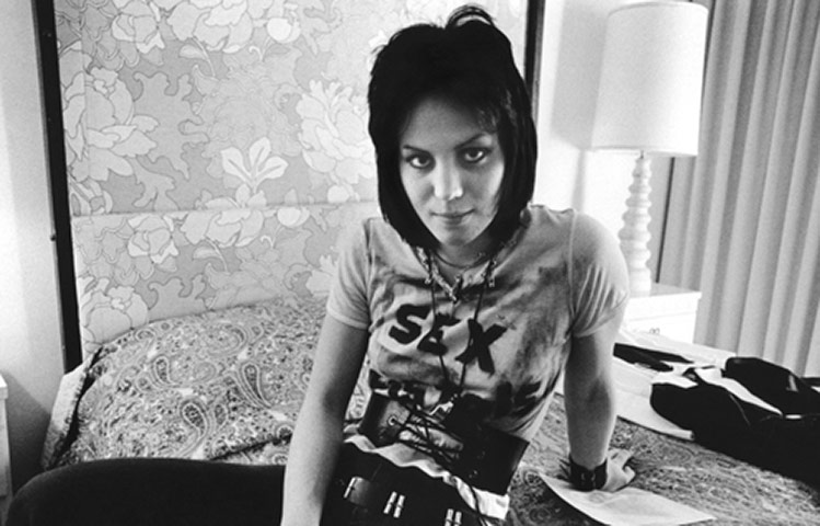 Rock Seen by Bob Gruen: Joan Jett of The Runaways on a bed in Los Angeles