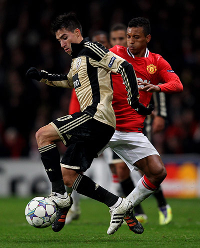 Tuesday Champions League: Nicolas Gaitan sheilds the ball from Nani