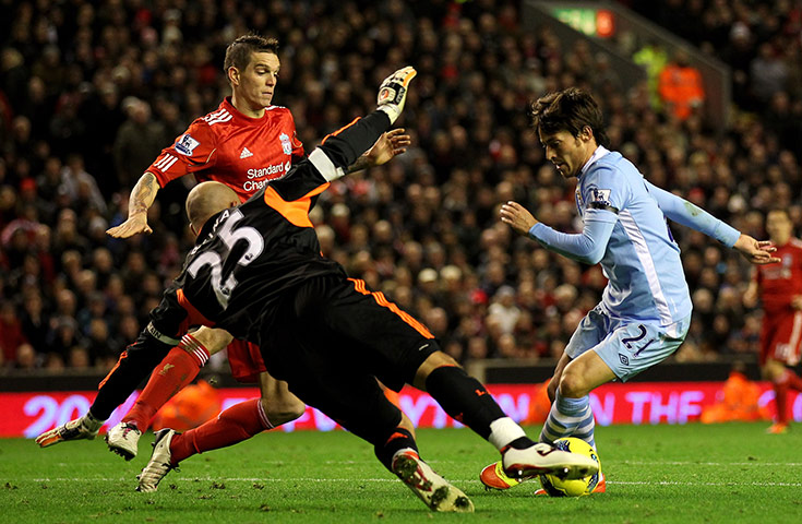 Sunday football: Manchester City's David Silva looks for a way past Pepe Reina of Liverpool 