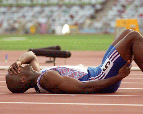An anguished Derek Redmond is helped towards the finish line by his father after suffering an injury in the 400m semi-final at the Barcelona Games in 1992