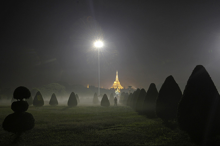 24 hours in pictures: A woman exercises in a public park near Shwedagon pagoda in Rangoon