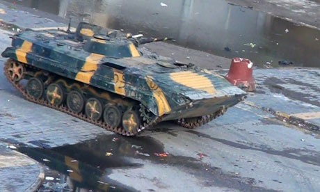 Syrian tank driving through the city of Homs
